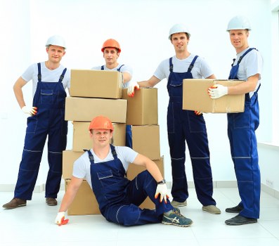 Loading furniture and boxes into a removal van in a local Beckenham street