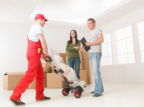 Professional movers carrying furniture from a property in Beckenham