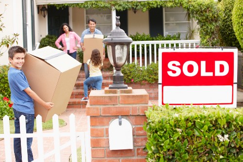 Helper carrying boxes during a Beckenham house move